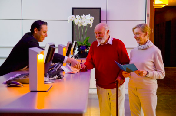 Senior discounts in Arizona and Goodyear include hotels like this picture of people checking in