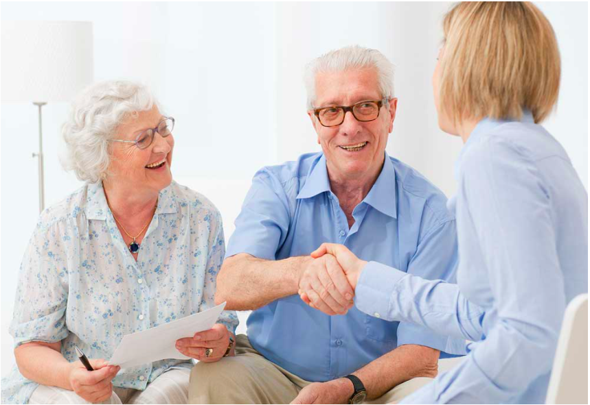 Elderly people shaking hands with financial counselor to learn about free services for senior citizens